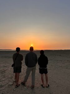 Three peoples at Ras Mohammed national park, looking an beautiful colorful sunset, Egypt.